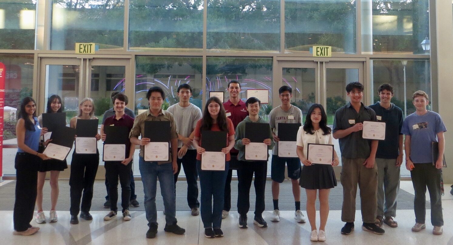 The night's award winners stand in a row holding their certificates in the North Lobby.